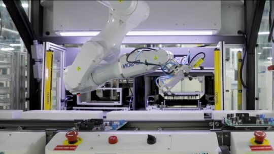 robotic arm preforming a manufacturing function in a factory