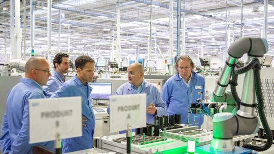 a group of manufacturing factory professionals collaborating on a project