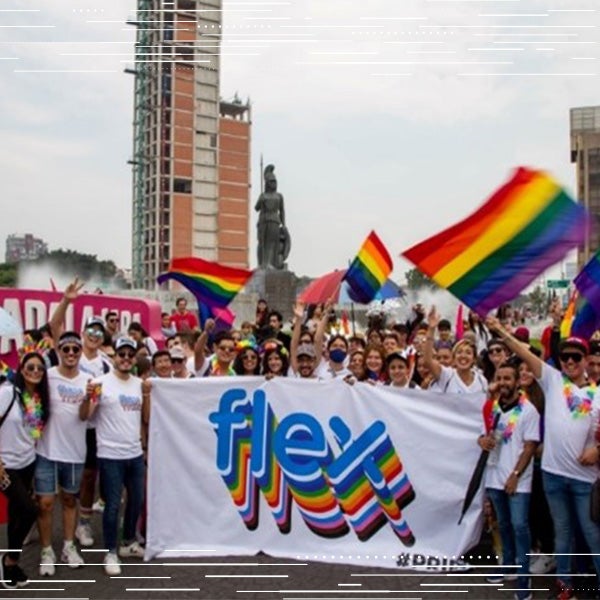 Flex employees gather outside to celebrate LGBTQ inclusivity with a rainbow colored flex banner
