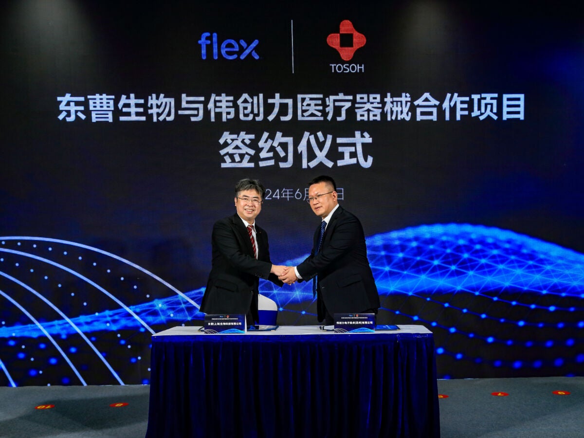Tosoh Bioscience shaking hands with Flex representative in Suzhou, China