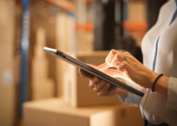 woman managing inventory on a tablet