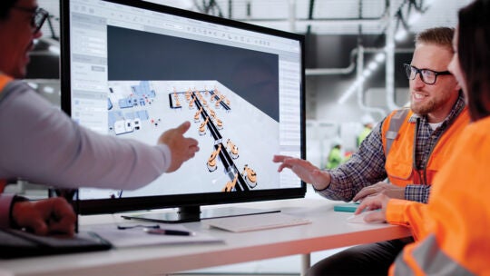 team of engineers collaborating in front of a screen