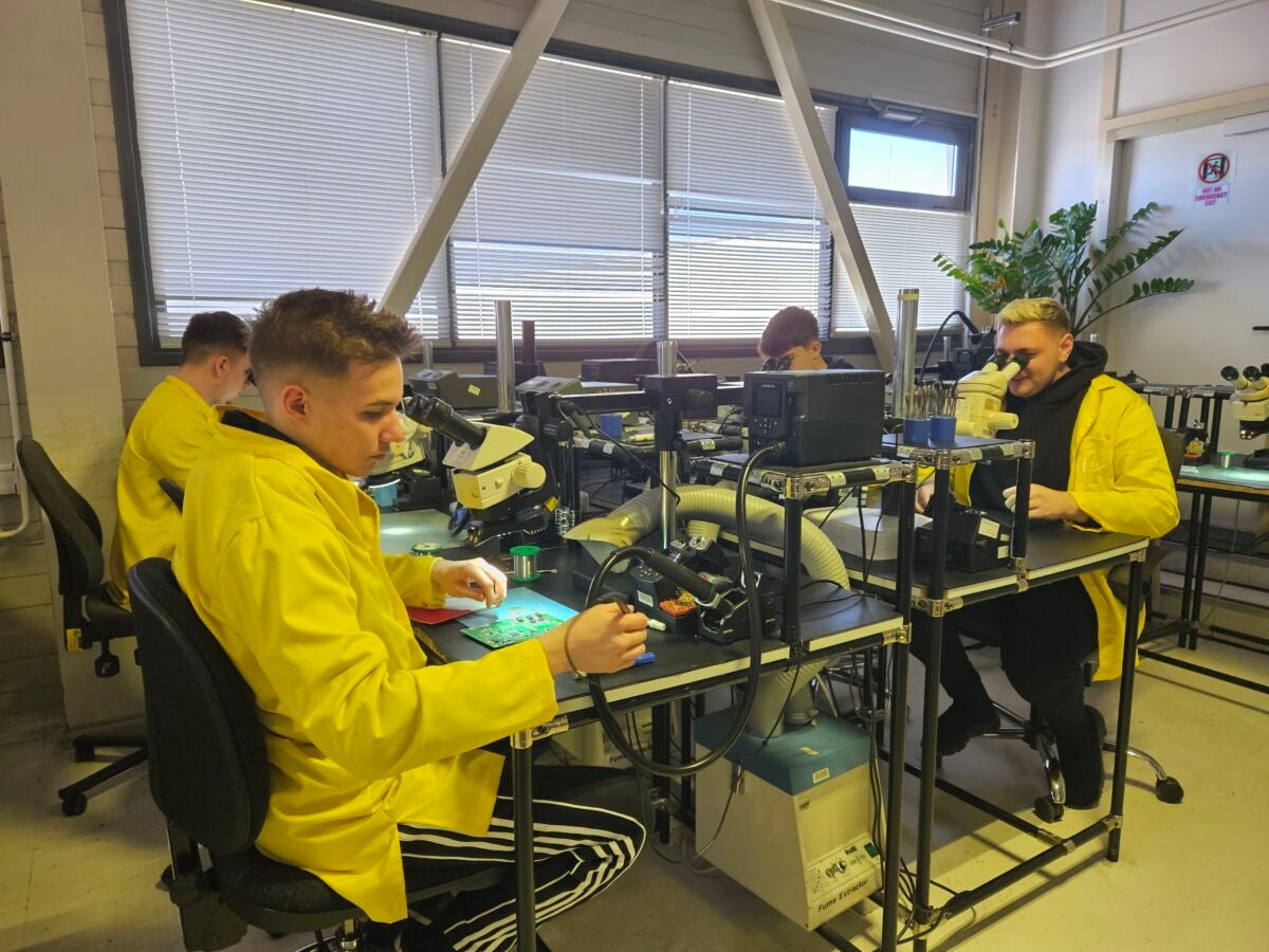 flex interns working at soldering stations