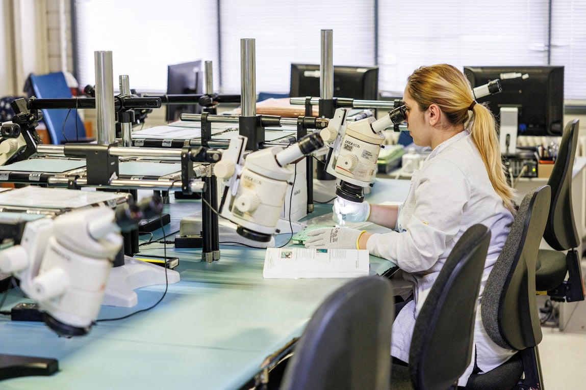 Flex engineer working at a microscope