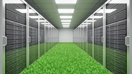 A data center corridor lined with server racks on both sides, with bright ceiling lights and a floor covered entirely in green grass.