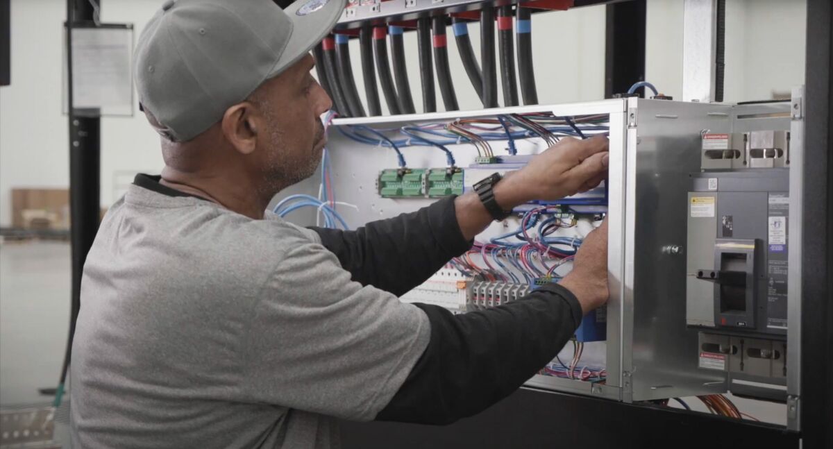 Flex employee working on a switchgear
