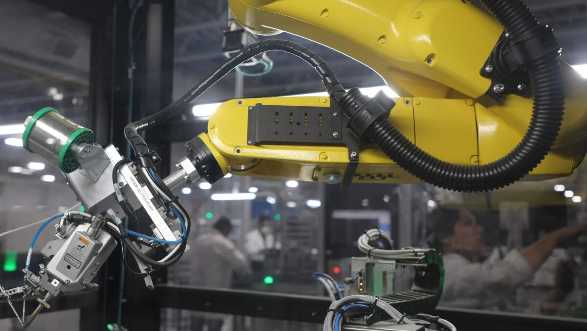 Yellow robotic arm on the manufacturing floor at Flex in Juarez, Mexico