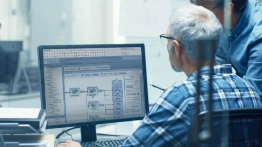 engineers working at a computer