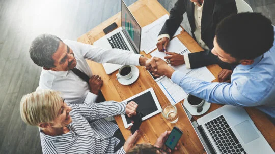 Team of people working together at a desk