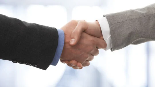 two hands engaged in a handshake