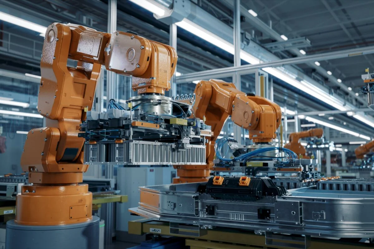 Orange manufacturing arms working on a production line