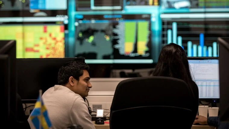 Two people working within the Flex Pulse center for vendor-managed inventory (VMI) solutions