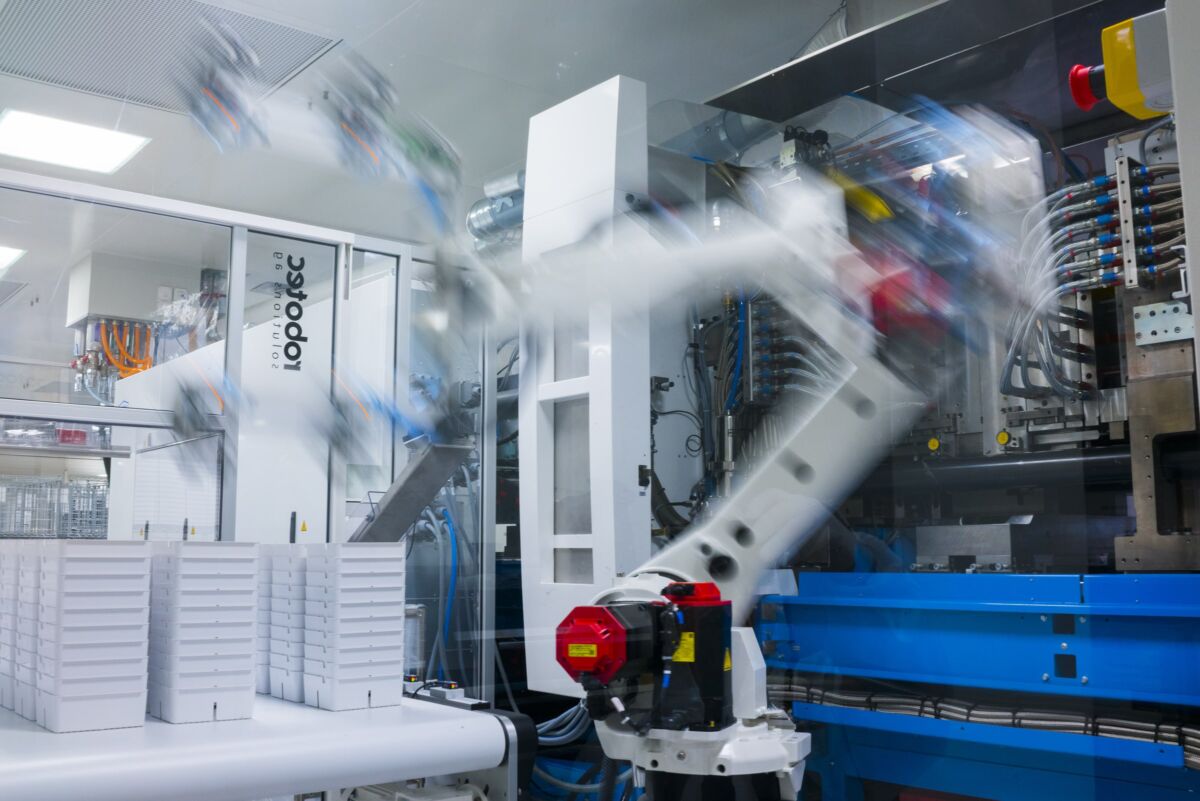 IVD manufacturing with a robotic arm for medical devices